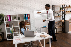 Picture of man writing on a board Mentor