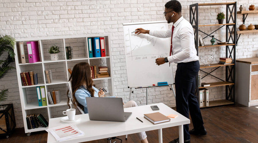 Picture of man writing on a board Mentor